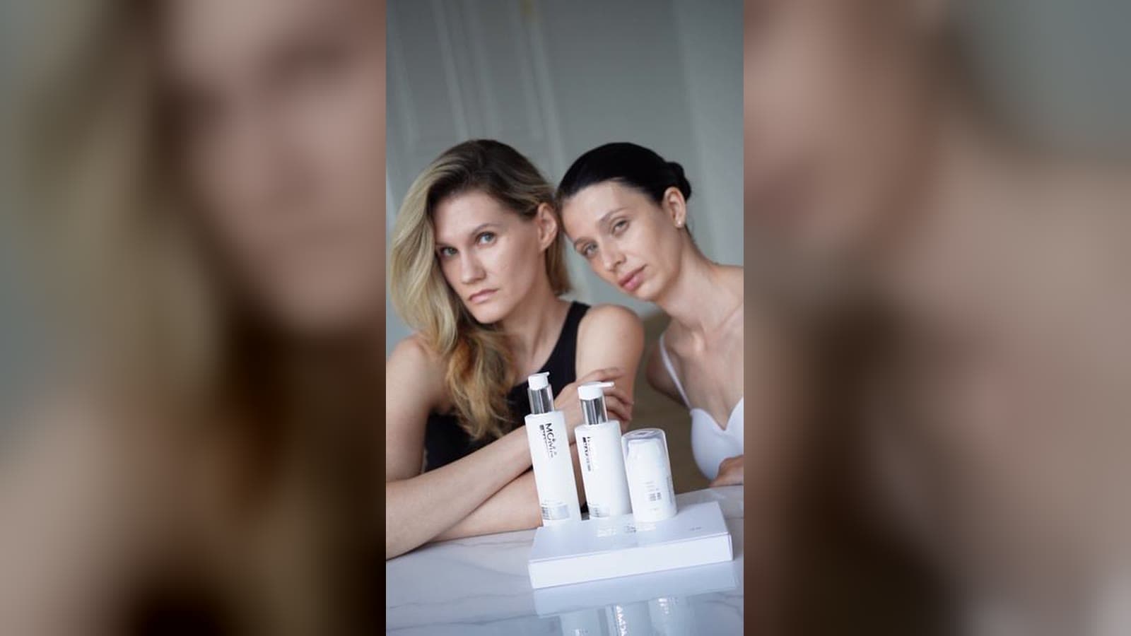 Two models at a table with the MOMA MATRIX line, a still from the shoot