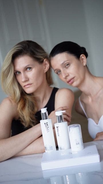 Two models at a table with the MOMA MATRIX line, a still from the shoot